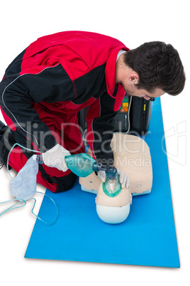 Paramedic practicing cardiopulmonary resuscitation on dummy