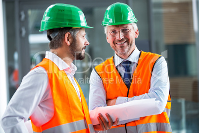 Architects standing with blueprint