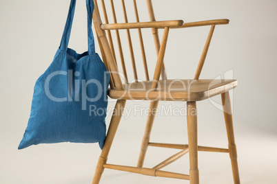 Blue bag hanging on a wooden chair