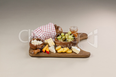 Loaf of bread with cheese, knife and jam