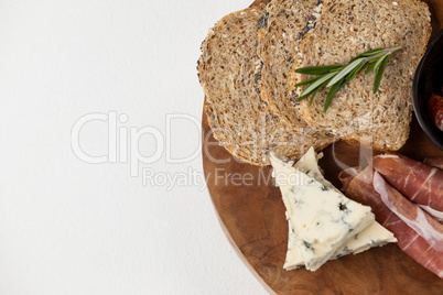 Bread slice, cheese and meat on wooden board