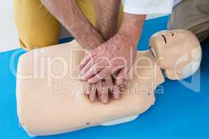 Paramedics training cardiopulmonary resuscitation to man