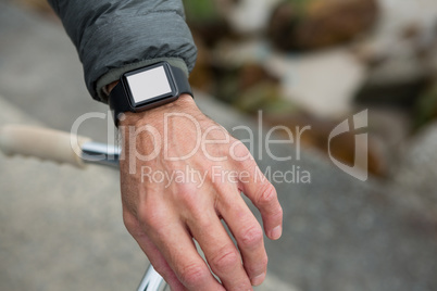 Close-up of mans hand wearing smartwatch