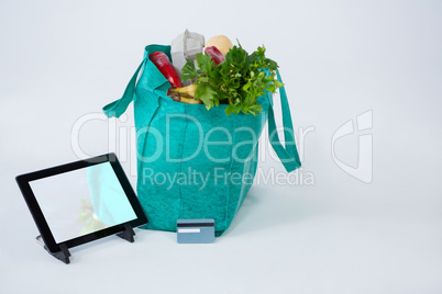 Grocery bag with credit card and digital tablet
