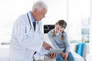 Doctor and patient discussing over digital tablet