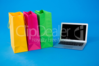 Colorful shopping bags with laptop