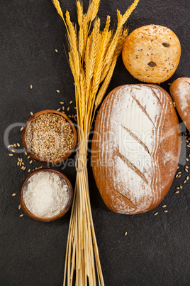 Bread loaves with wheat grains and flour