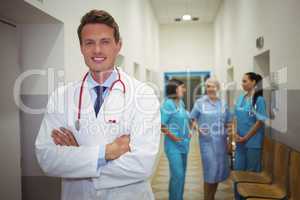 Portrait of male doctor standing in corridor
