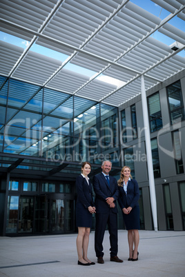 Confident businesspeople standing in the office premises