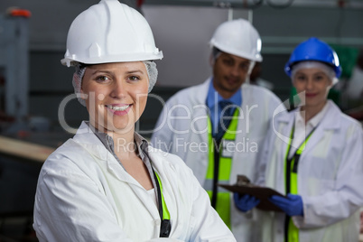 Technicians standing in meat factory