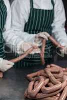 Butchers processing sausages