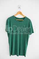 Green t-shirt with pocket on hanger
