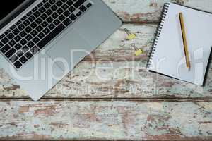 Laptop with notepad and pencil