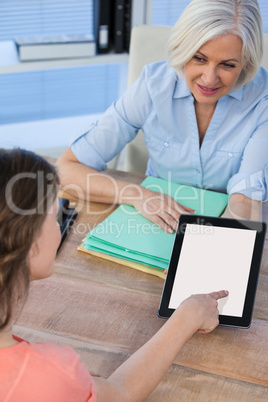 Doctor discussing with patient over digital tablet at the hospital