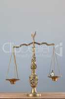 Conceptual image of pocket watch on justice scale