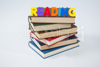 Reading letter blocks on stack of books