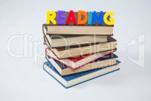 Reading letter blocks on stack of books