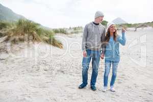 Happy mature couple pointing at view