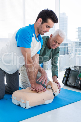 Paramedic training cardiopulmonary resuscitation to man