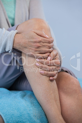 Patient holding her injured knee