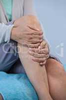 Patient holding her injured knee