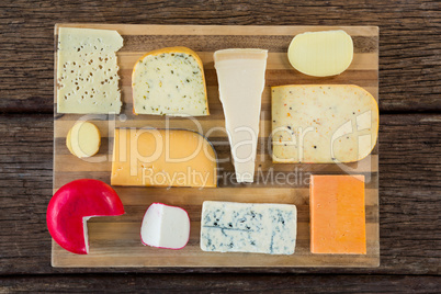 Variety of cheese on wooden board