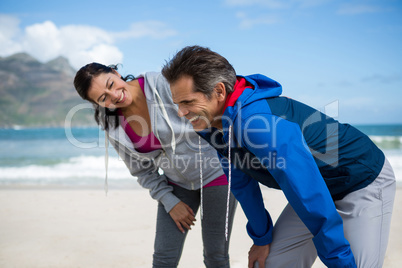 Happy couple taking a break after jogging