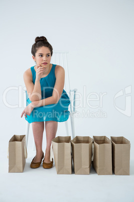 Woman sitting with shopping bags
