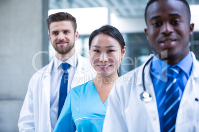 Confident nurse standing with colleagues