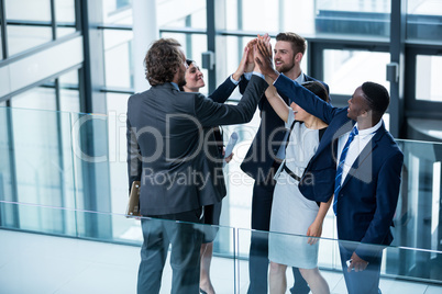 Businesspeople giving high five to each other