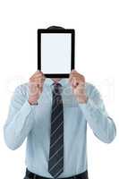 Businessman holding digital tablet in front of his face