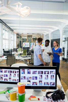 Graphic designers interacting with each other while having meal