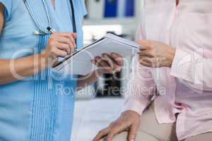 Doctor showing prescription to patient