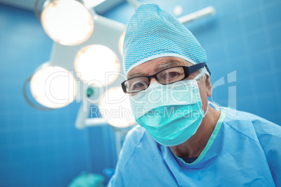 Portrait of male surgeon wearing surgical mask in operation theater