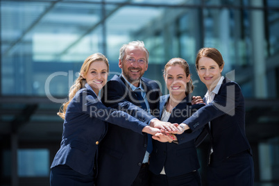 Businesspeople stacking hands together