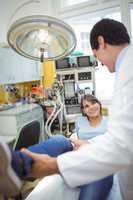 Doctor examining a female patients leg