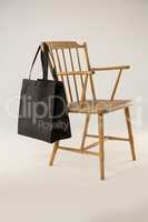 Black bag hanging on a wooden chair