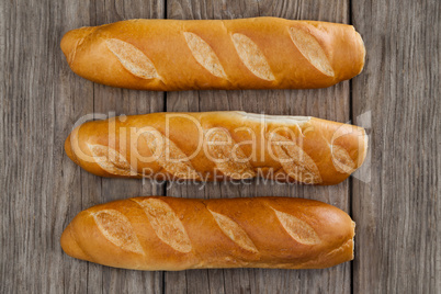 Baguettes on wooden background