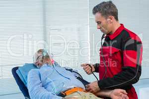 Paramedic checking blood pressure of patient