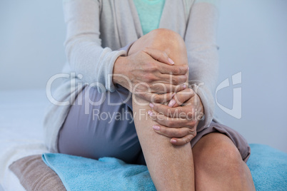 Patient holding her injured knee