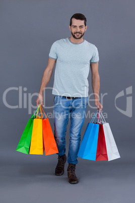 Man holding colourful shopping bags