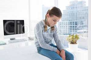 Depressed girl sitting on the examination table