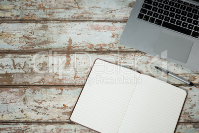 Laptop and diary with pen