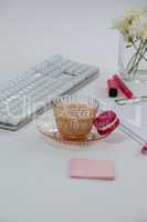 Cup of tea with a french macaroon and sticky notes