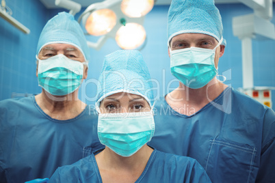 Team of surgeons wearing surgical mask in operation theater