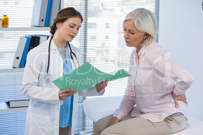 Doctor discussing with patient over medical report