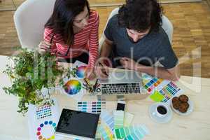 Graphic designers working at desk