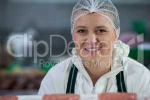 Female butcher at meat factory
