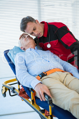 Paramedic examining the patient