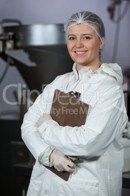 Female butcher holding clipboard